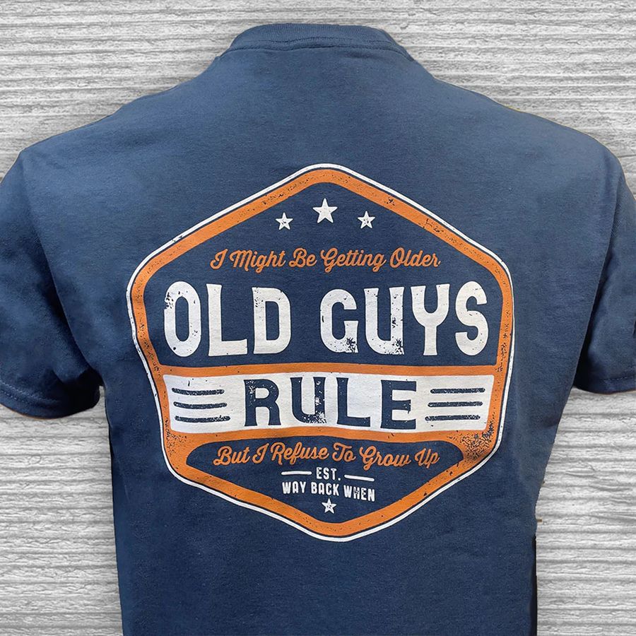 Navy blue t-shirt with 'Old Guys Rule' graphic on the back against a gray textured background
