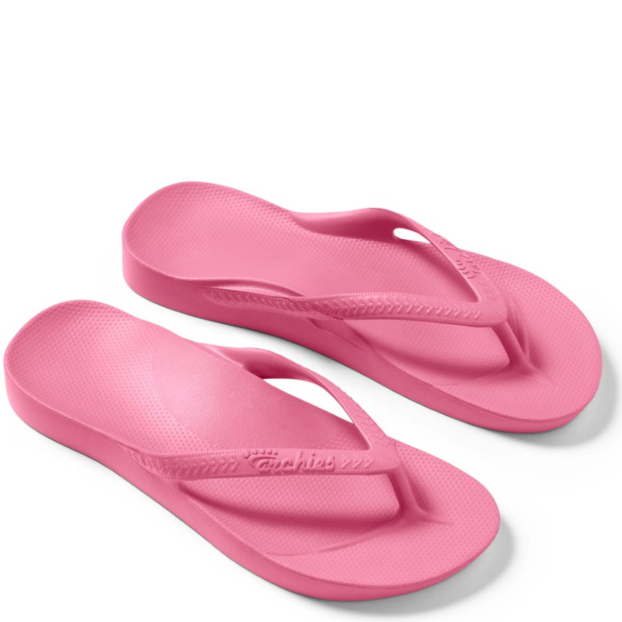 Pair of pink flip-flops on a white background
