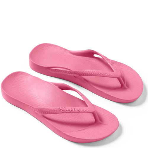 Pair of pink flip-flops on a white background