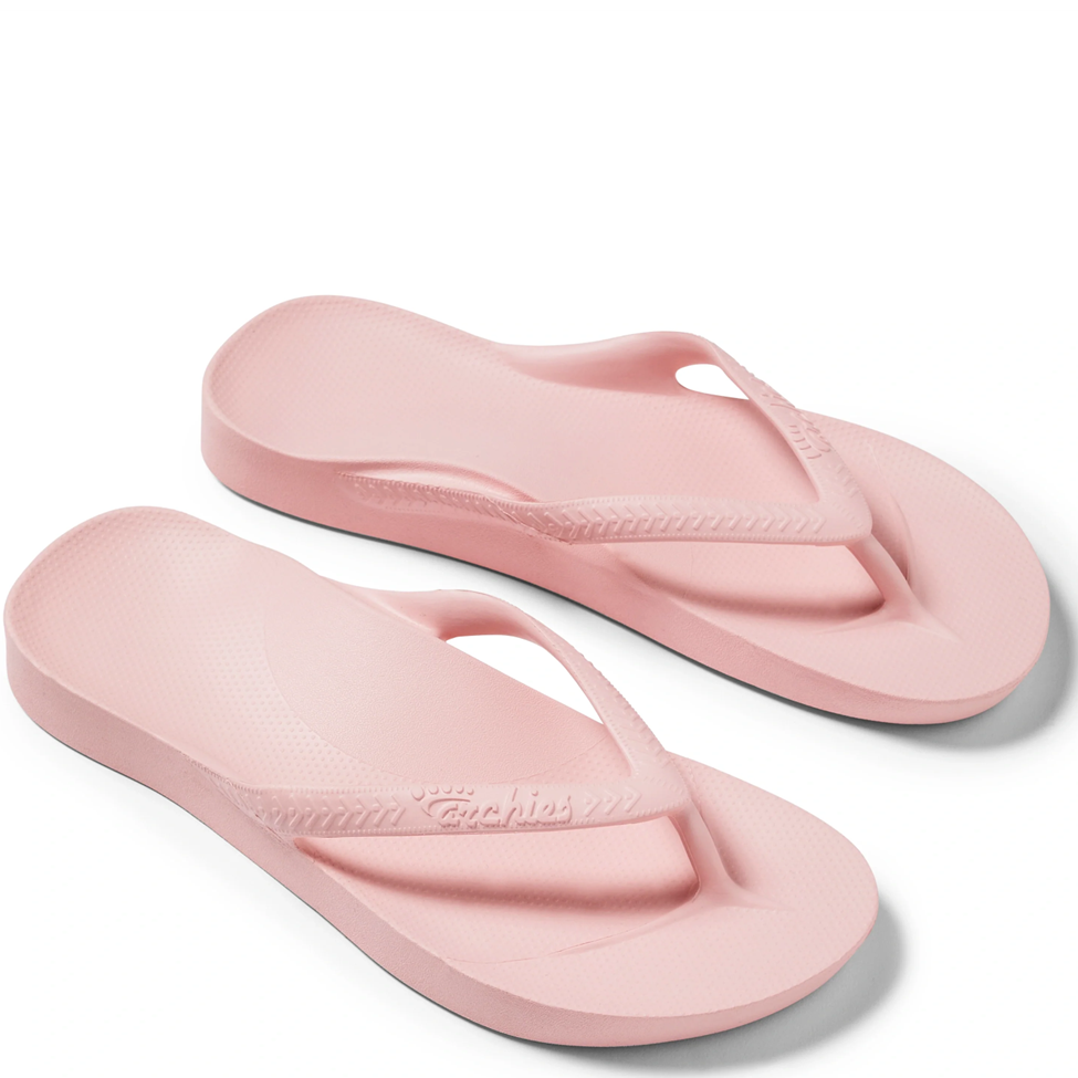 Pair of pink flip-flops on a white background