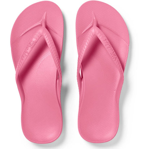 Pair of pink flip-flops on a white background