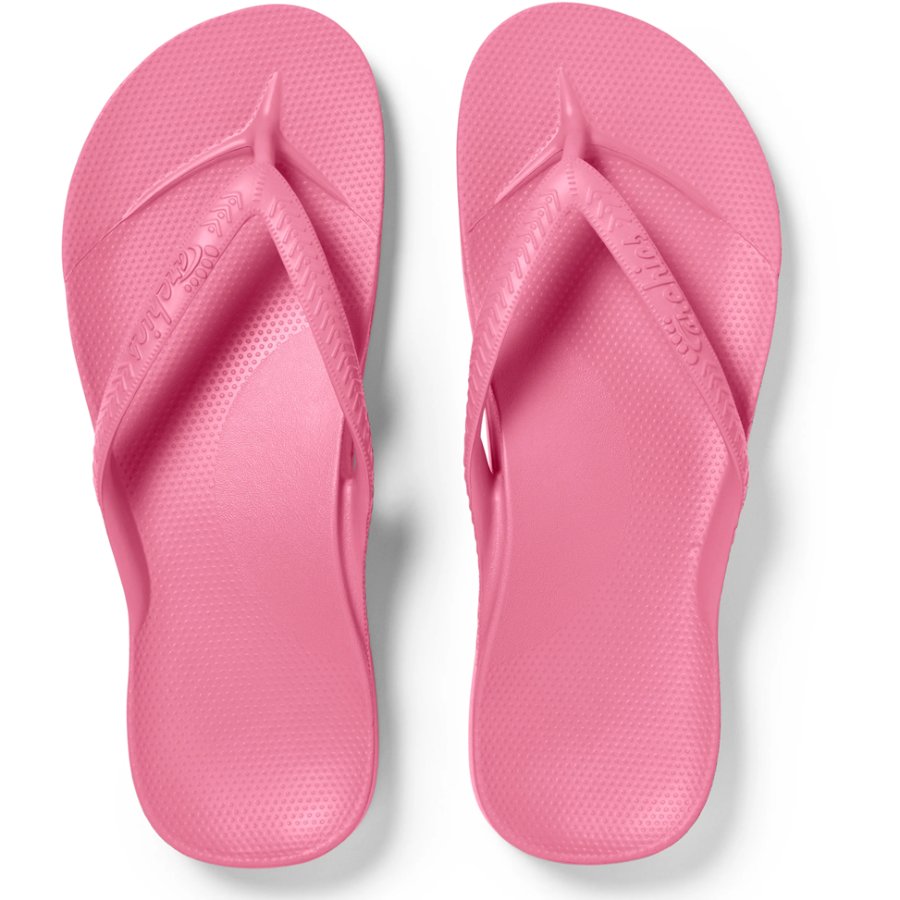 Pair of pink flip-flops on a white background