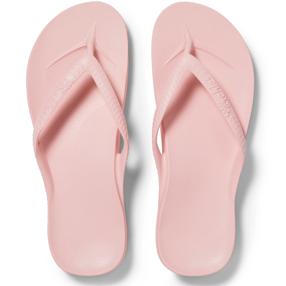 Pair of pink flip-flops on a white background
