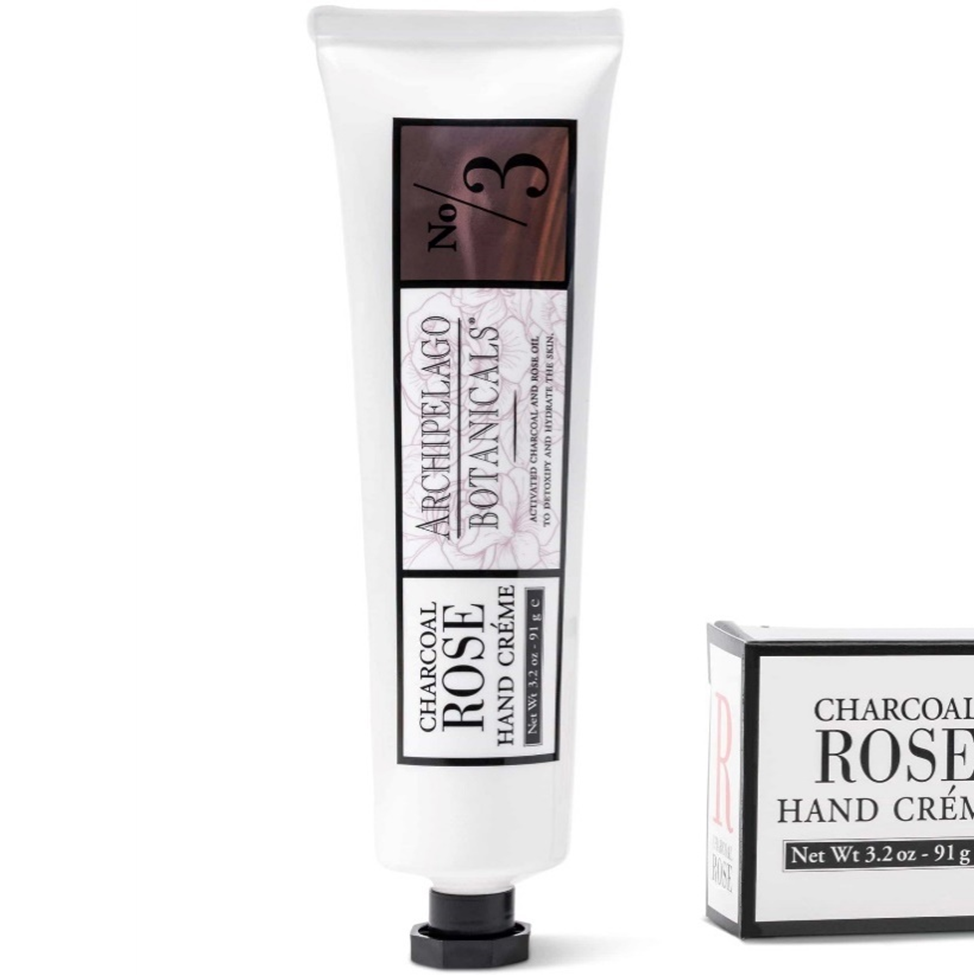 Tube and packaging of Archipelago Botanicals Charcoal Rose Hand Creme on a white background