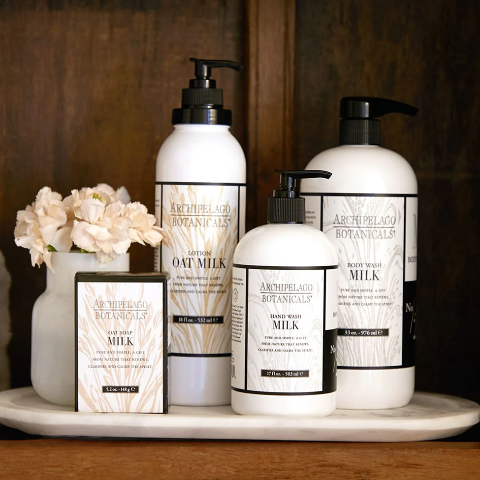 Archipelago Botanicals skincare products on a wooden surface with flowers.