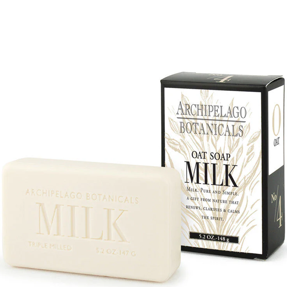 Bar of Archipelago Botanicals Milk soap next to its packaging on a white background