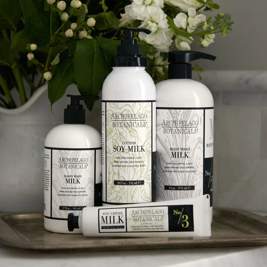 Archipelago Botanicals skincare products on a tray with flowers in the background