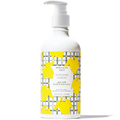 Bottle of Beekman 1802 Sunshine Lemon goat milk hand & body lotion with yellow lemon illustrations on a white background.