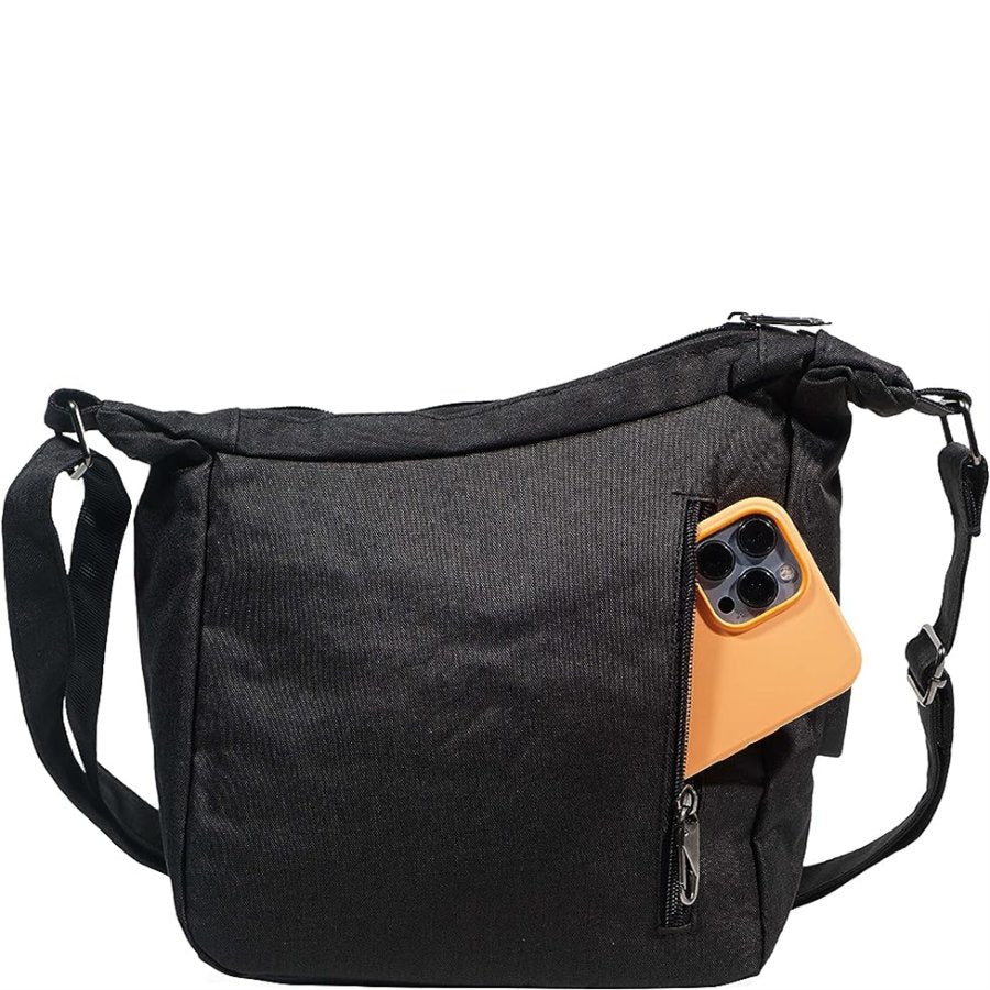 Black shoulder bag with a pocket containing a phone on a white background