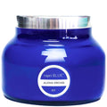 Blue candle jar with silver lid and 'capri BLUE' label on a white background