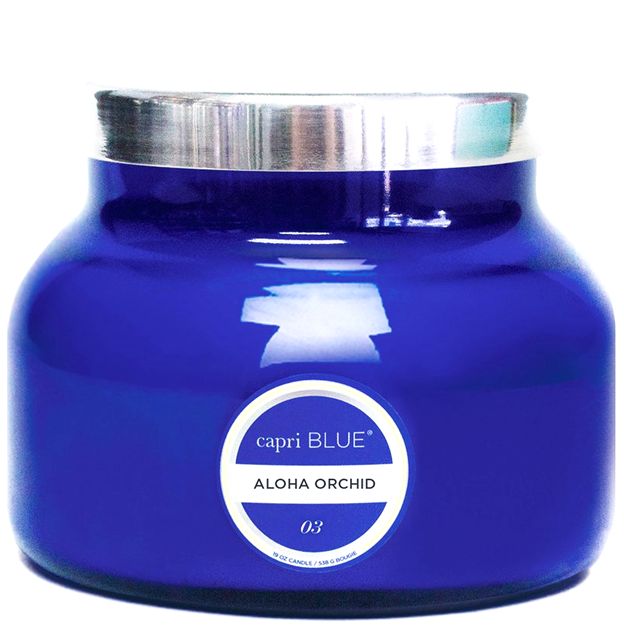 Blue candle jar with silver lid and 'capri BLUE' label on a white background