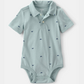 Light blue baby onesie with whale pattern on a white background