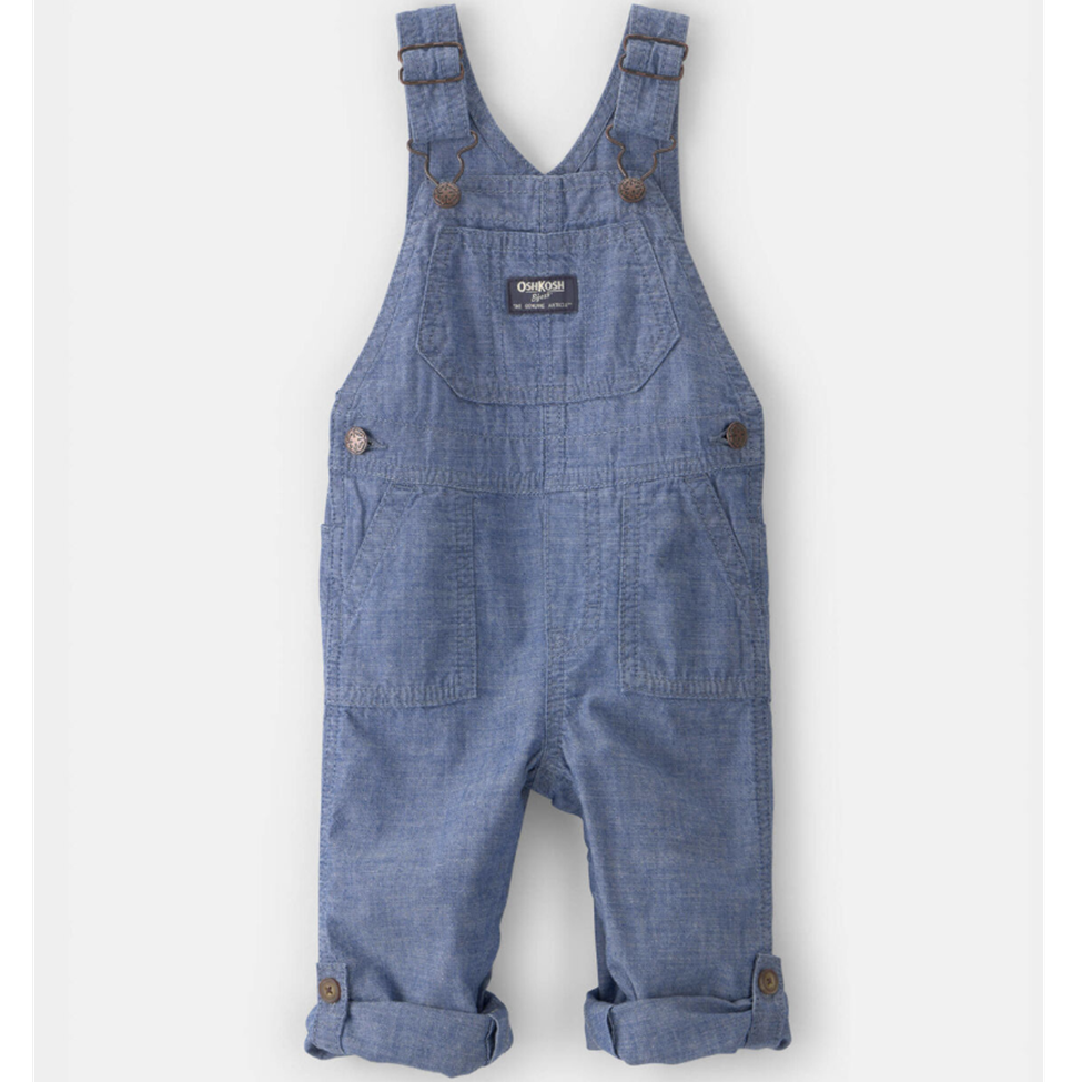 Blue denim overalls on a white background
