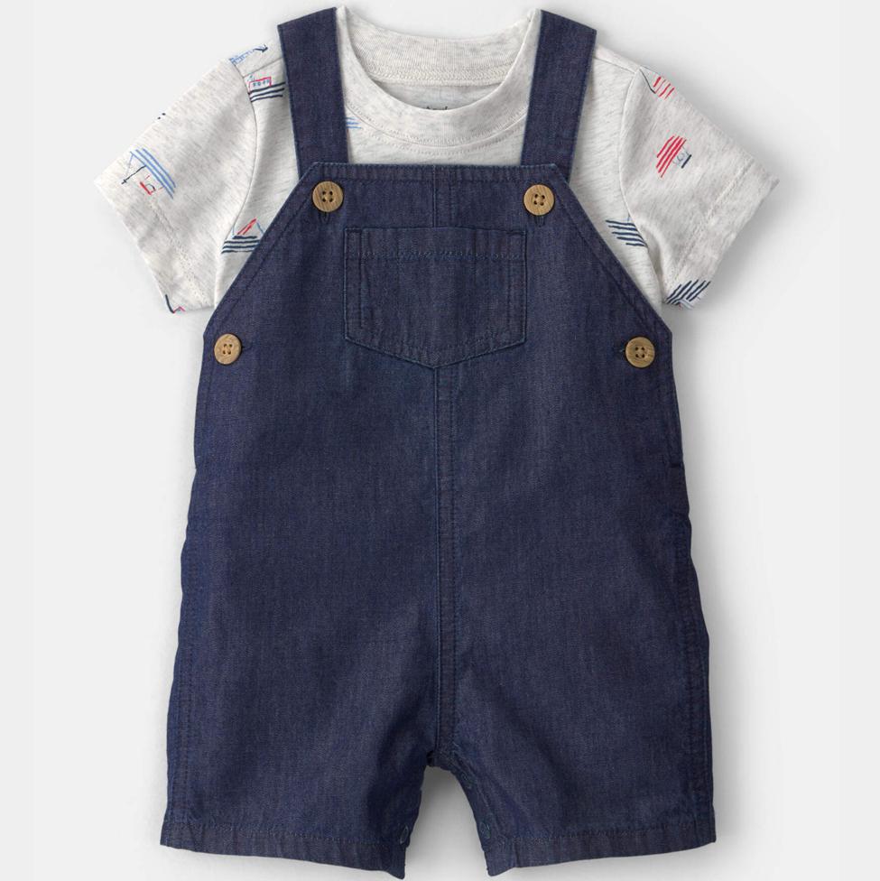 Children's outfit with denim overalls and a patterned shirt on a white background
