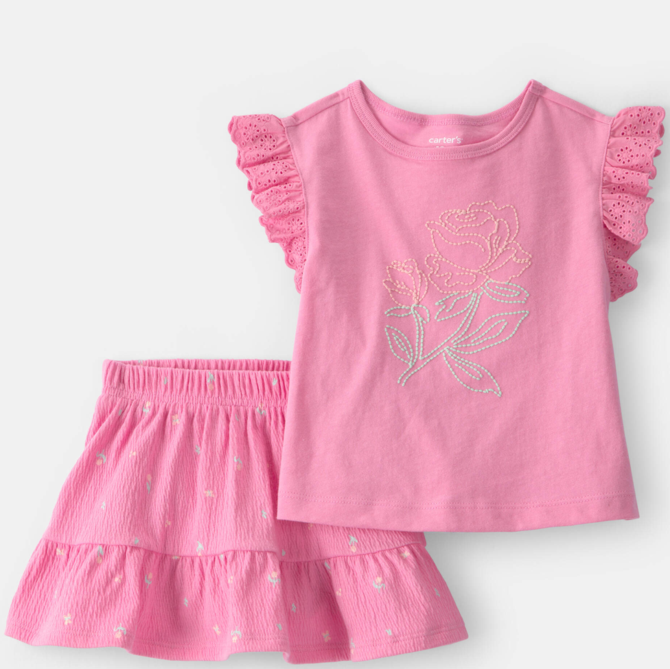 Pink children's outfit with a floral design on a white background