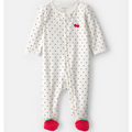 Baby onesie with polka dot pattern and red accents on a white background