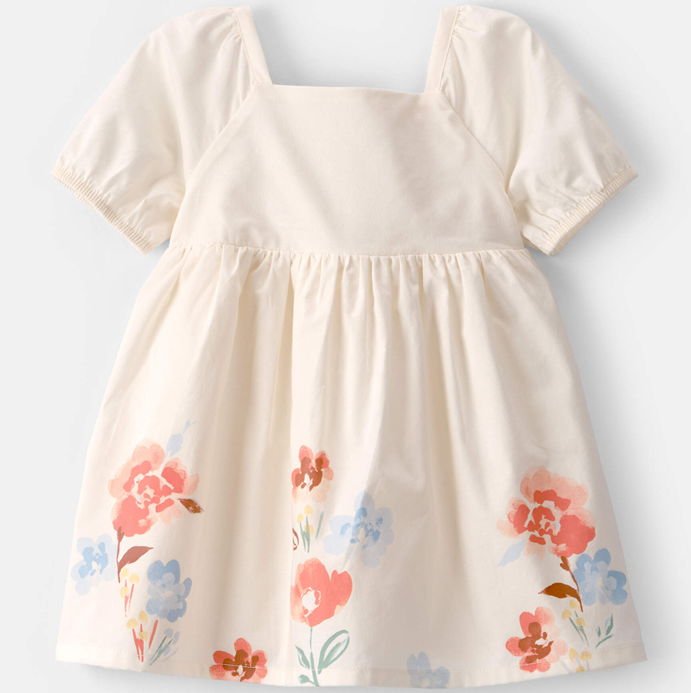 Beige dress with floral patterns on a light gray background