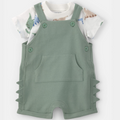 Green romper with dinosaur print shirt on a white background