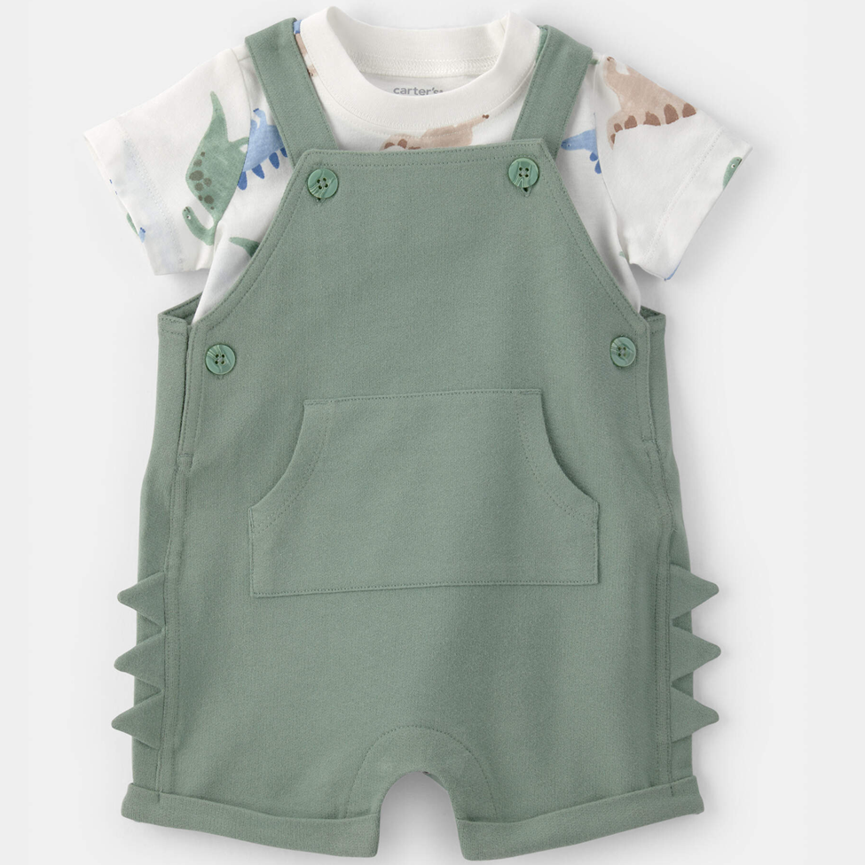 Green romper with dinosaur print shirt on a white background