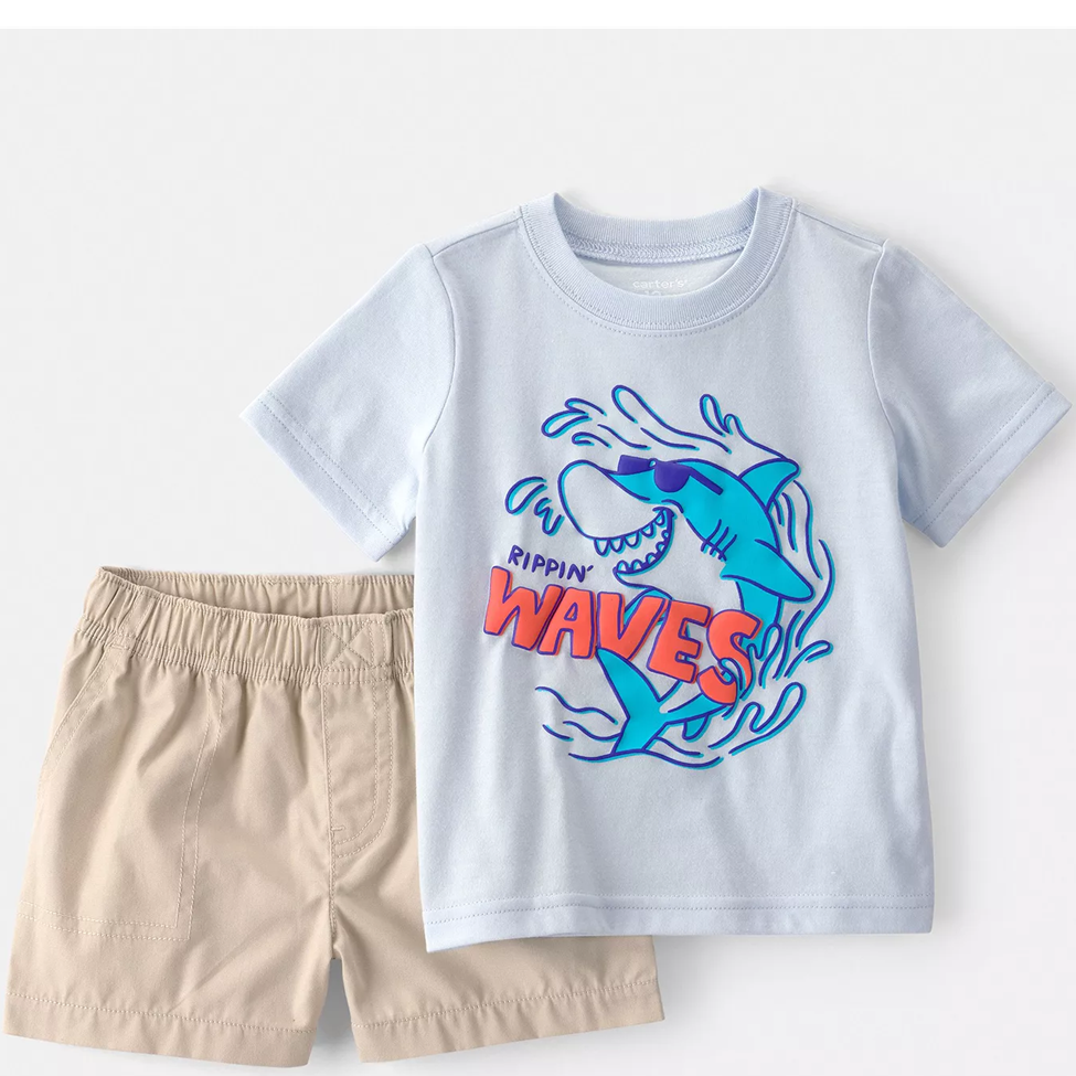 Children's t-shirt with shark graphic and shorts on a light gray background