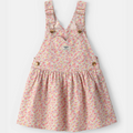 Floral patterned pinafore dress on a white background