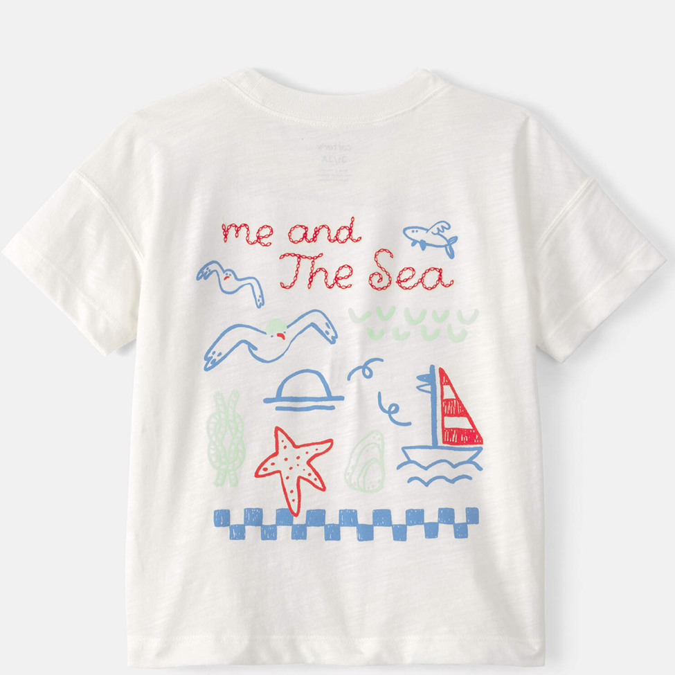 White t-shirt with colorful sea-themed graphics and text on a white background