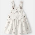White floral overalls dress with brown buttons on a white background