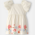 Beige dress with floral patterns on a white background