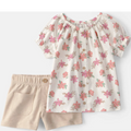 Floral top and beige shorts set on a white background