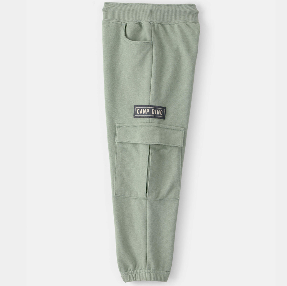 Green jogger pants with a 'Camp Dino' label on a white background