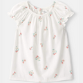 White blouse with floral embroidery on a white background