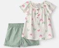 Floral top and green shorts set on a white background