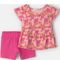 Children's outfit with floral top and pink shorts on a white background
