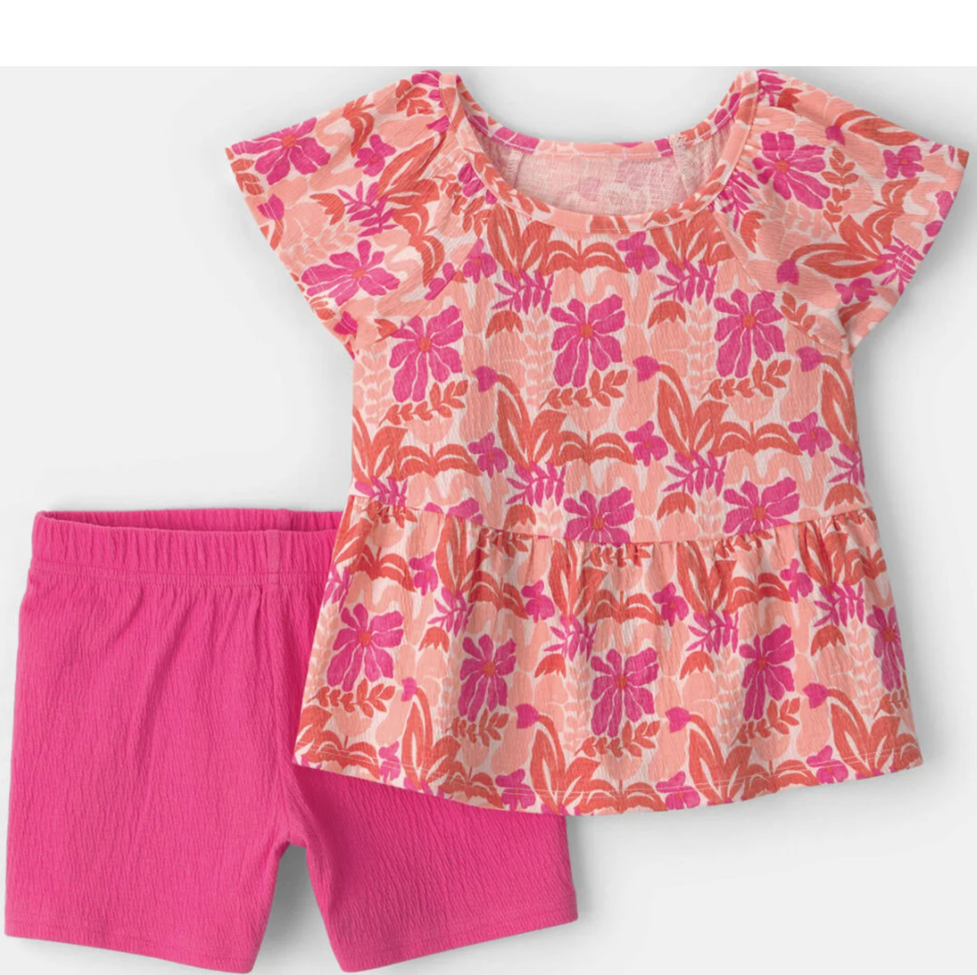 Children's outfit with floral top and pink shorts on a white background