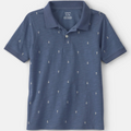 Blue polo shirt with anchor pattern on a white background