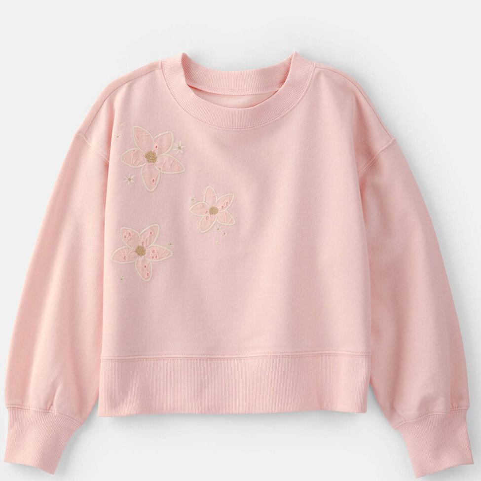 Pink sweatshirt with floral designs on a light gray background