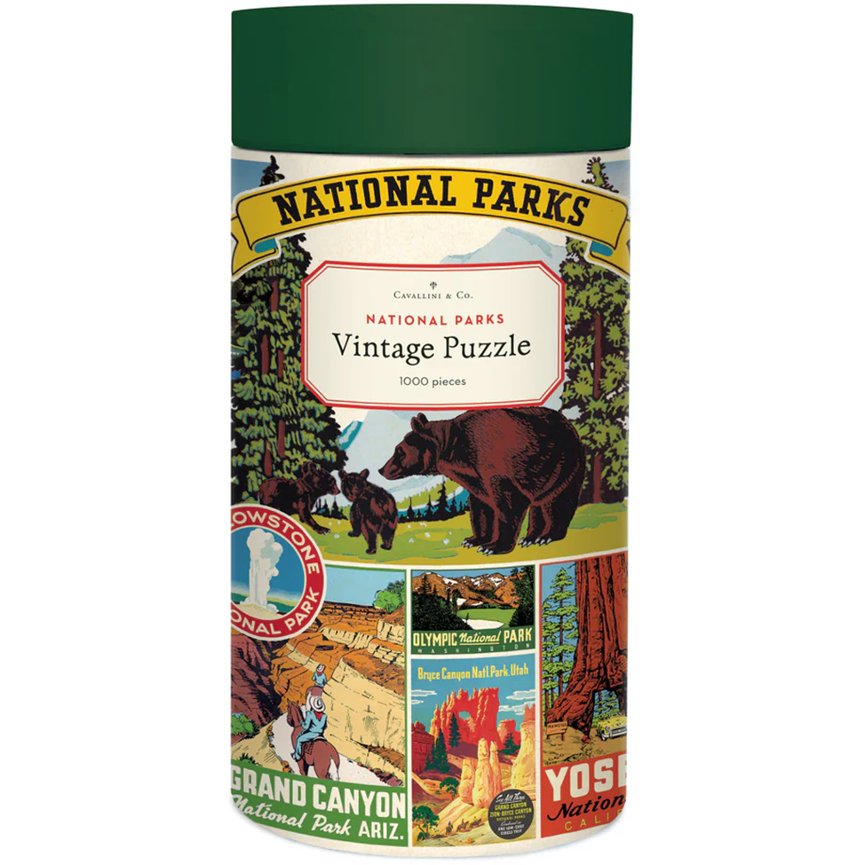 Cylindrical packaging for a vintage puzzle of national parks with illustrations and text.