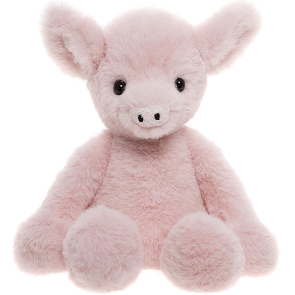 Pink plush pig toy on a white background