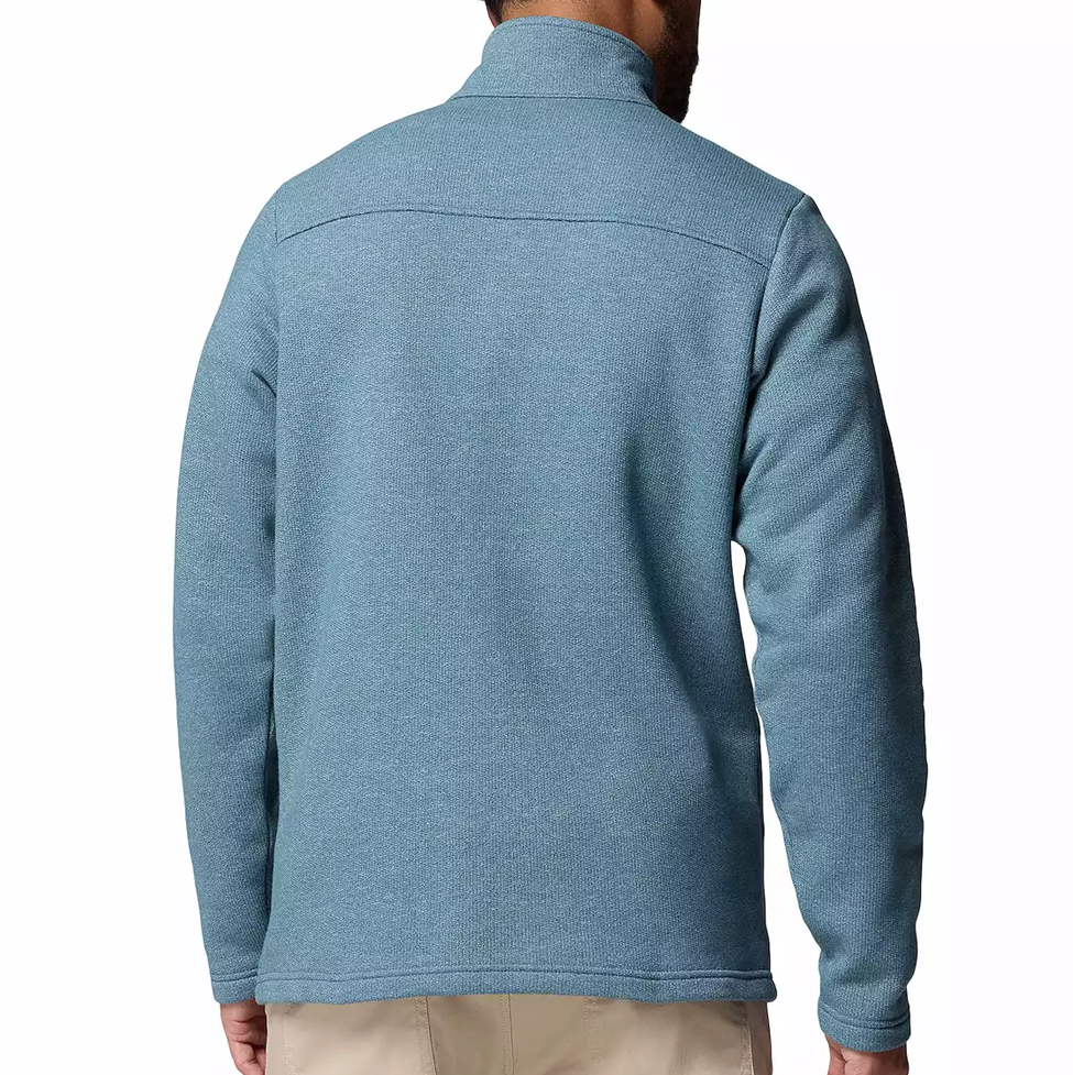 Blue fleece jacket worn by a person on a white background