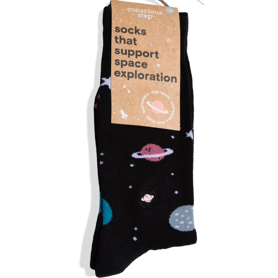 Black socks with space-themed designs and a 'consciously step' label on a white background