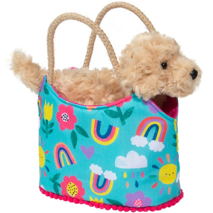 Toy dog  in a colorful bag with rainbow and cloud patterns on a white background