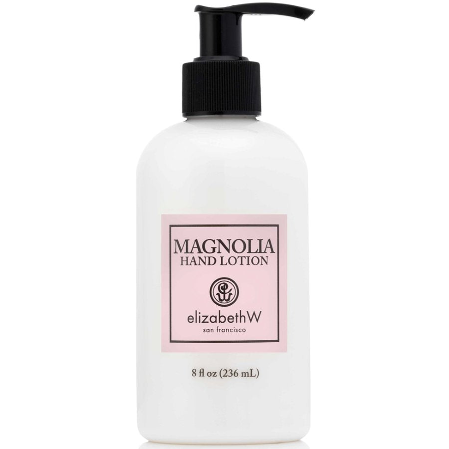 White bottle of Magnolia Hand Lotion with a black pump on a white background