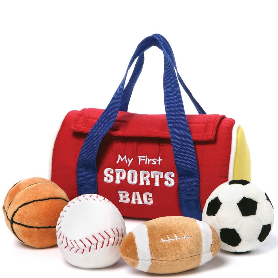 Red sports bag with blue handles and 'My First Sports Bag' text, surrounded by toy sports balls on a white background.
