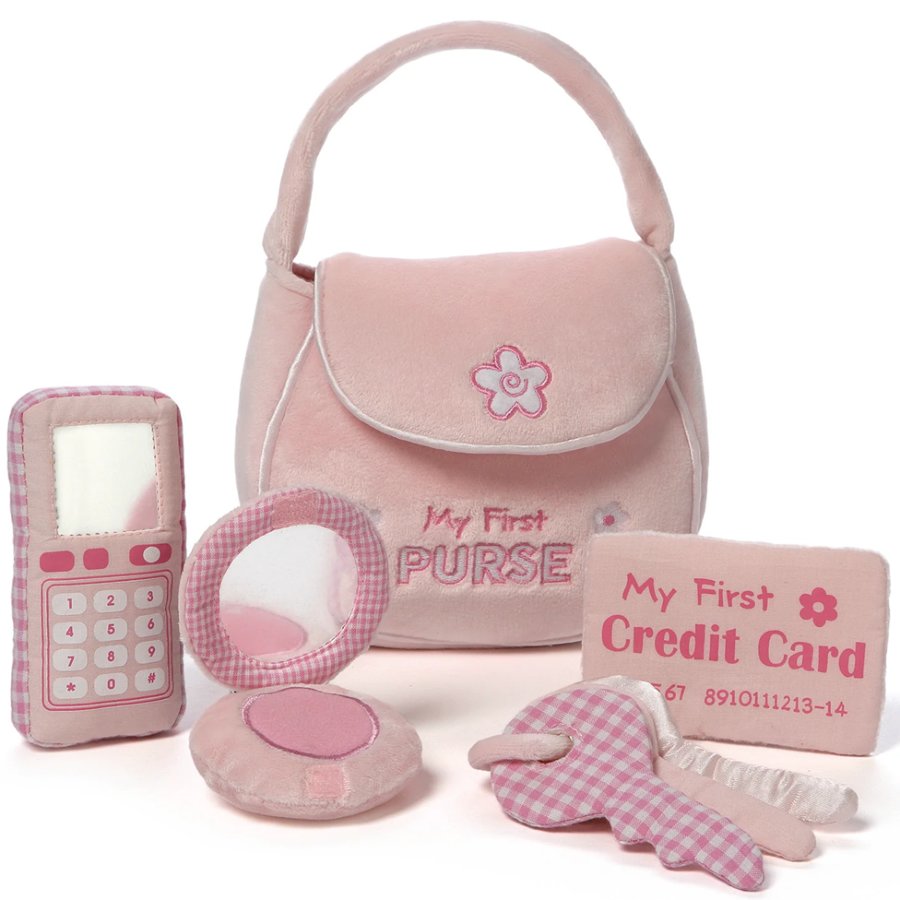 Set of pink toy accessories including a purse, phone, and credit card on a white background