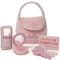 Set of pink toy accessories including a purse, phone, and credit card on a white background