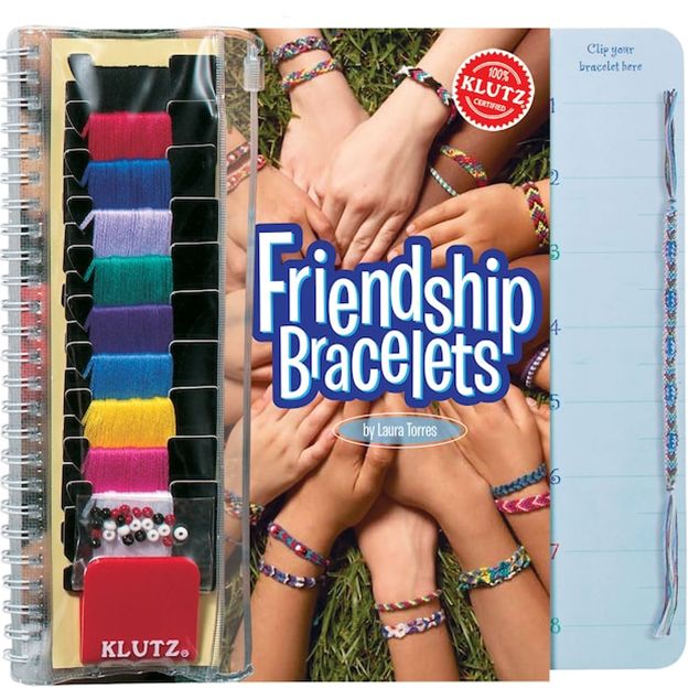 Klutz friendship bracelets kit with colorful bands and completed bracelets on a grassy background