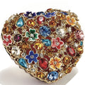 Decorative ring with colorful gemstones and floral designs on a white background