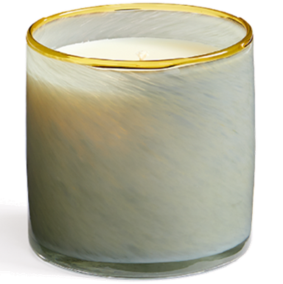 Candle in a glass container with a gold rim on a white background