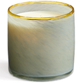 Candle in a glass container with a gold rim on a white background