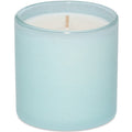 Candle in a light blue glass container on a white background